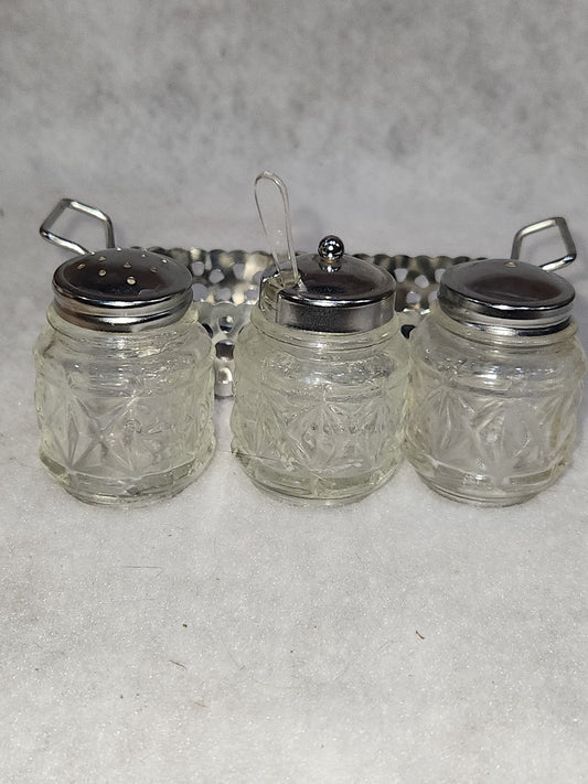 Vintage clear cut glass salt, pepper and condiment set in aluminum holder has tiny spoon sps24