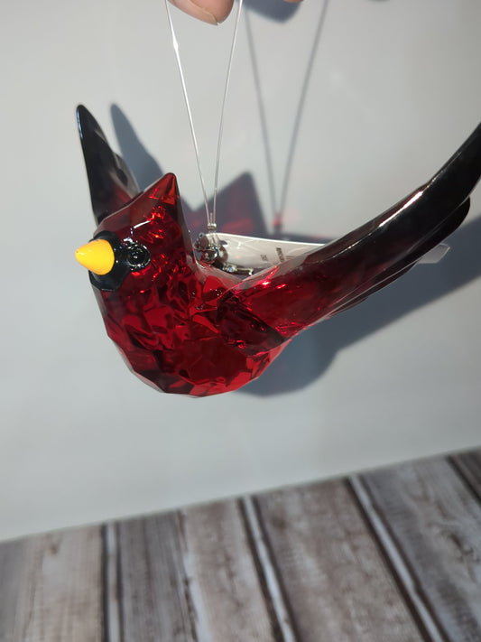 O77 Crystal Expressions Cardinal ornament with a charm.