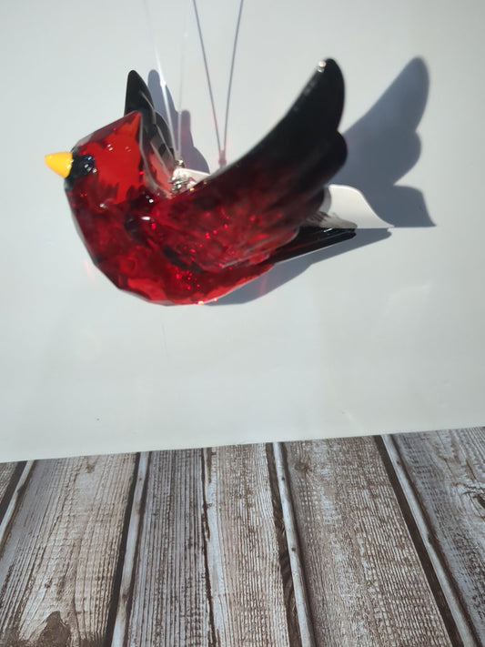 O77 Crystal Expressions Cardinal ornament with a charm.