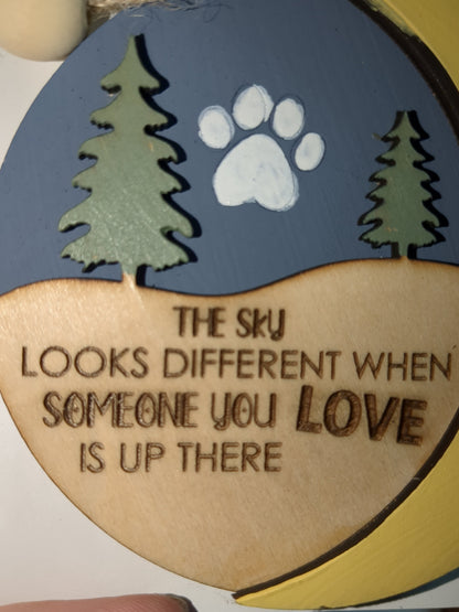 Ornament the sky looks different when someone you love is up there with pet paw. Memorial for loss of loved pet
