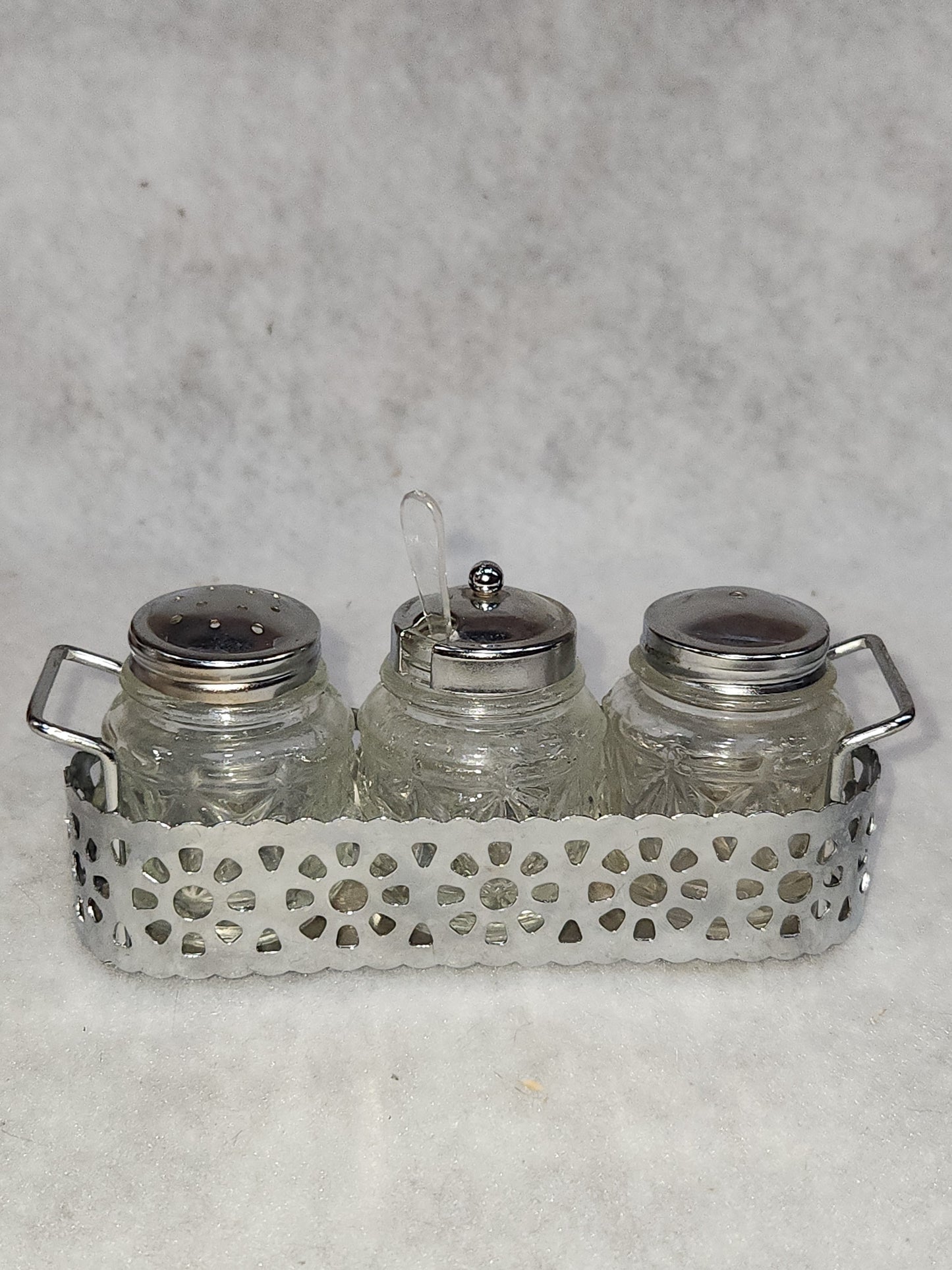 Vintage clear cut glass salt, pepper and condiment set in aluminum holder has tiny spoon sps24