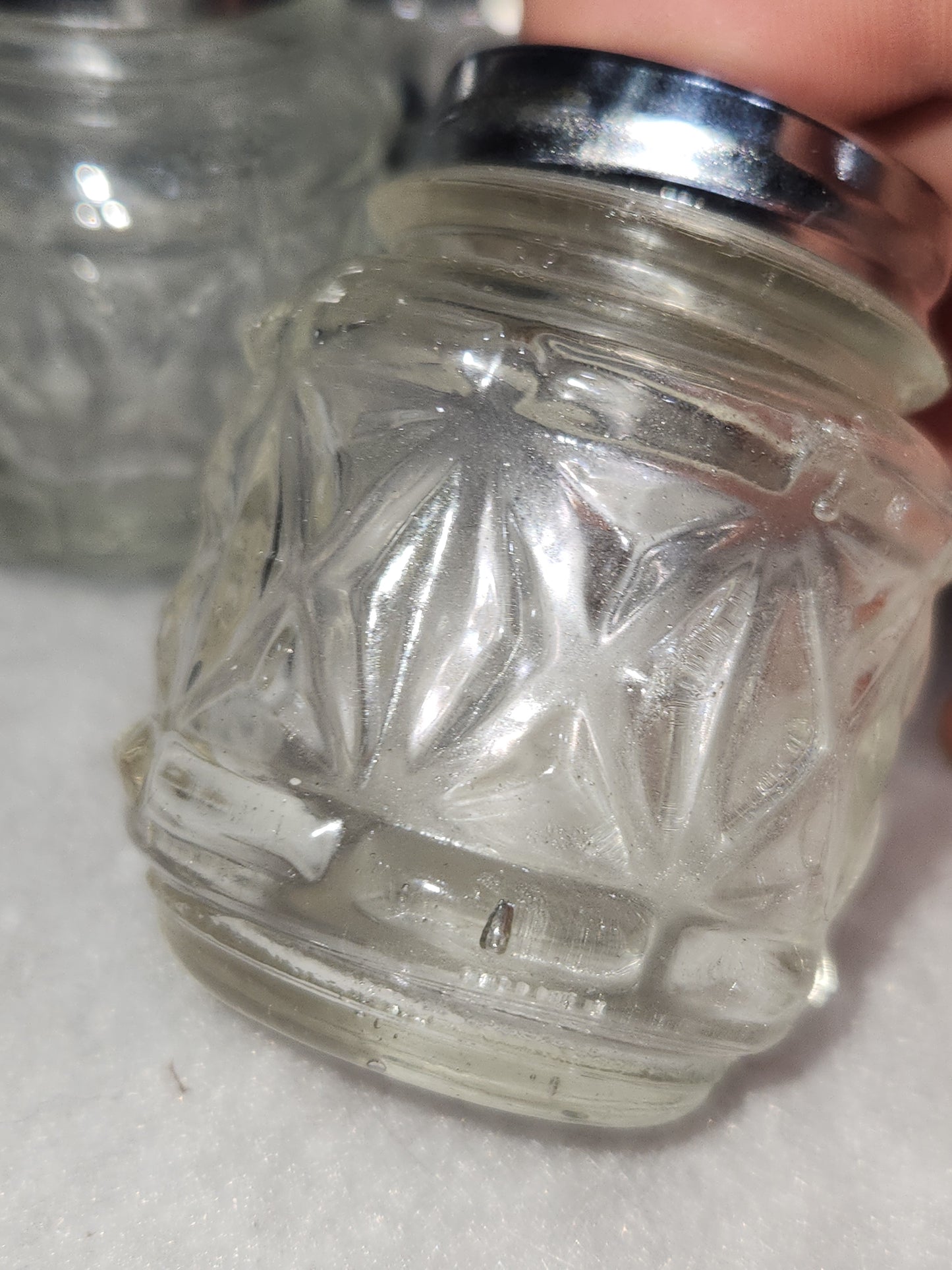 Vintage clear cut glass salt, pepper and condiment set in aluminum holder has tiny spoon sps24